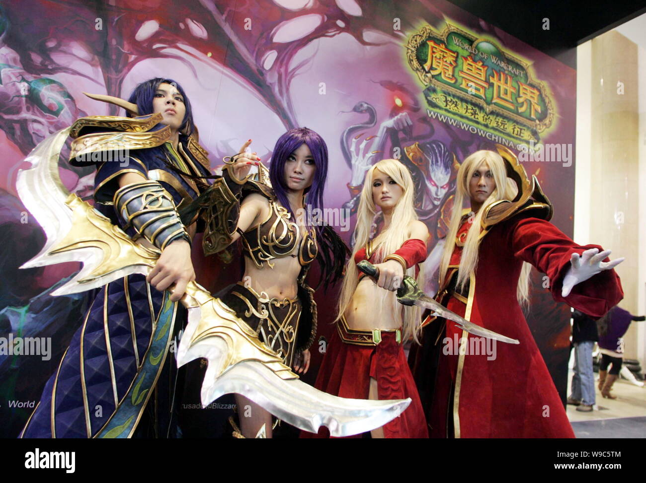--FILE--Chinese COSPLAY performers pose at the stand of the online game, World of Warcraft, during an exhibition in Beijing, China, 23 October 2008. Stock Photo