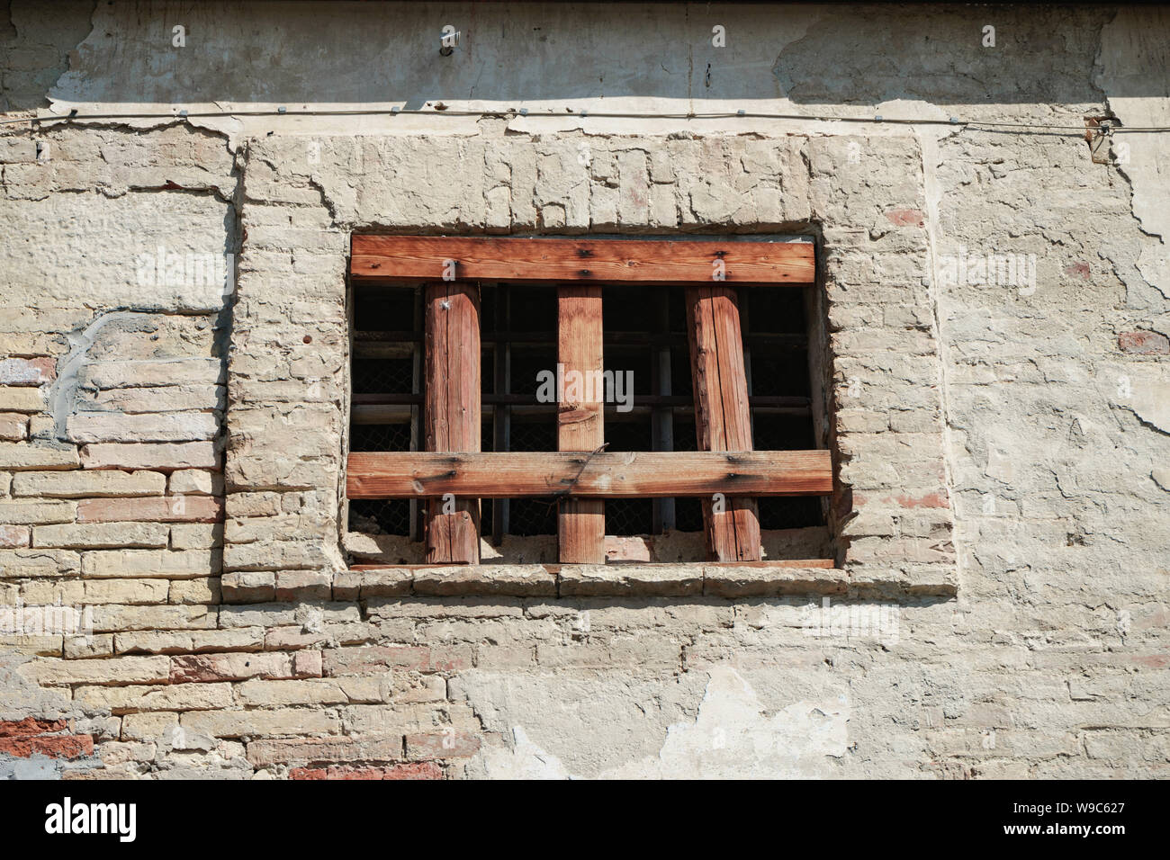 Old window of a brick building clogged with boards Stock Photo - Alamy