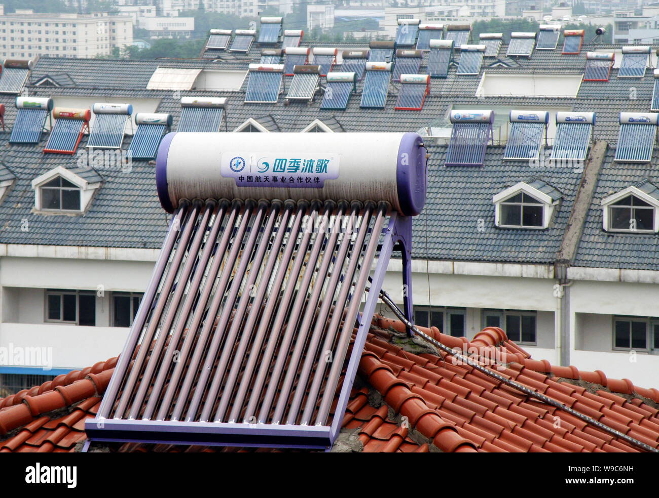 --FILE--Solar power water heaters are seen on top of residential ...
