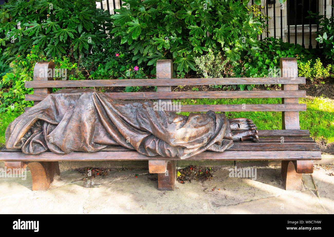 Statue of Jesus the Homeless by Timothy Schmalz on a park bench in