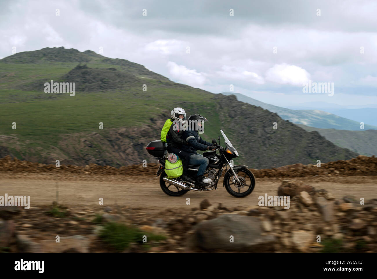 Russia, Sverdlovsk Oblast - July 19, 2018: two travelers on a motorcycle rushes down the mountain road Stock Photo