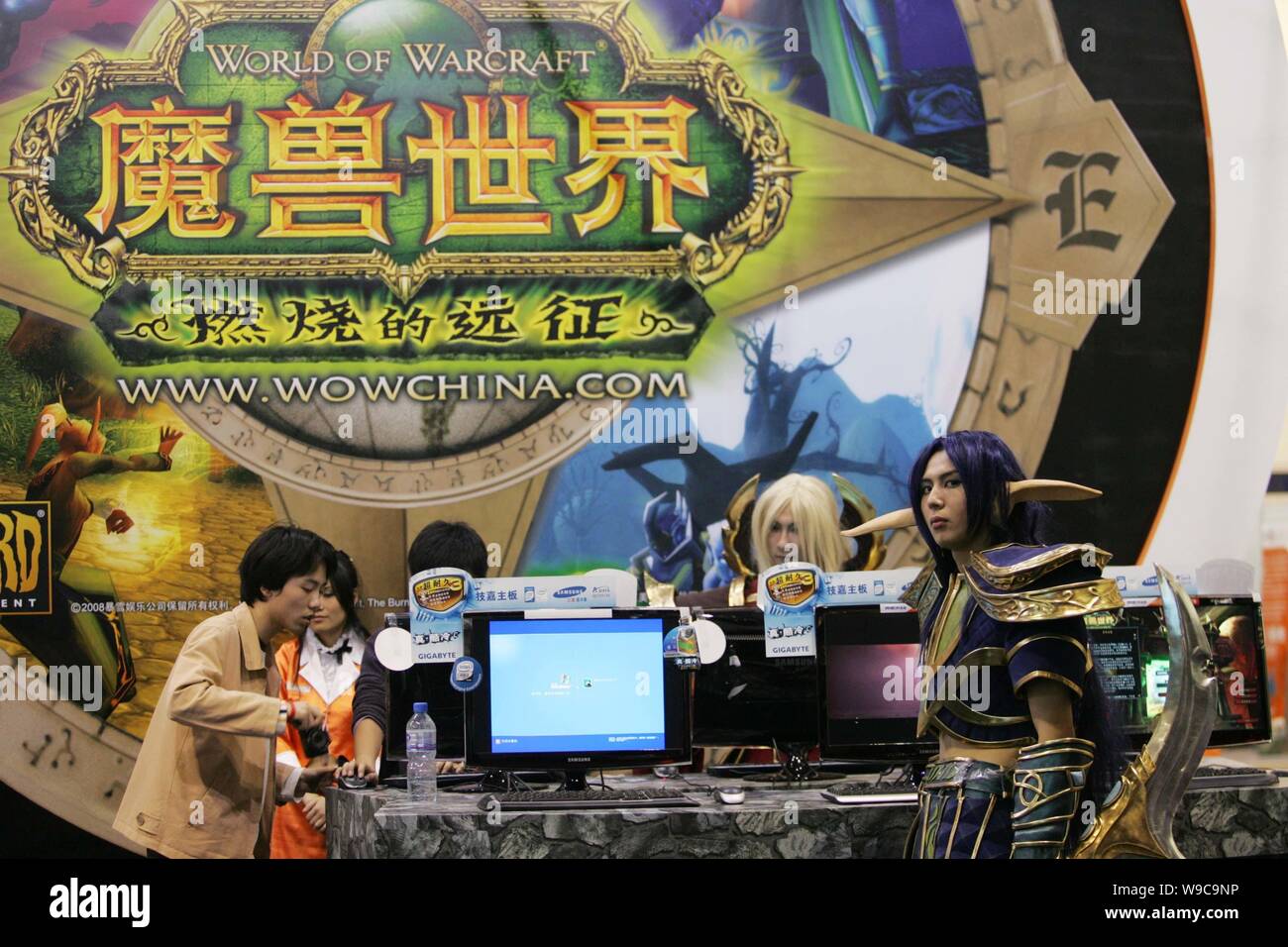 --FILE-- Chinese COSPLAY performers and visitors are seen at the stand of the online game, World of Warcraft, during an exhibition in Beijing, China, Stock Photo