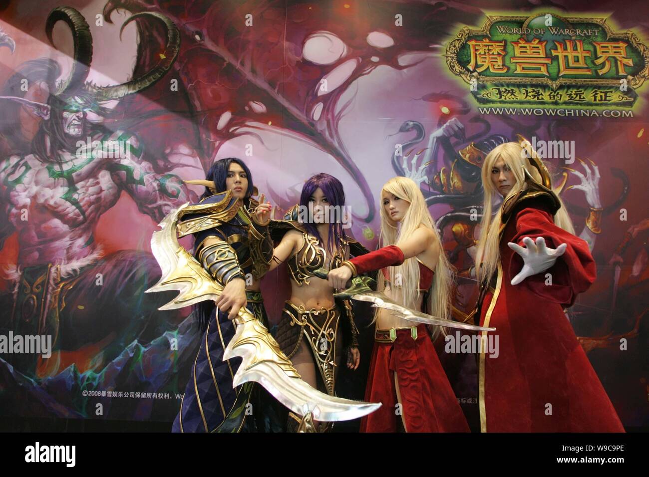 --FILE-- Chinese COSPLAY performers pose at the stand of the online game, World of Warcraft, during an exhibition in Beijing, China, July 25, 2009. Stock Photo