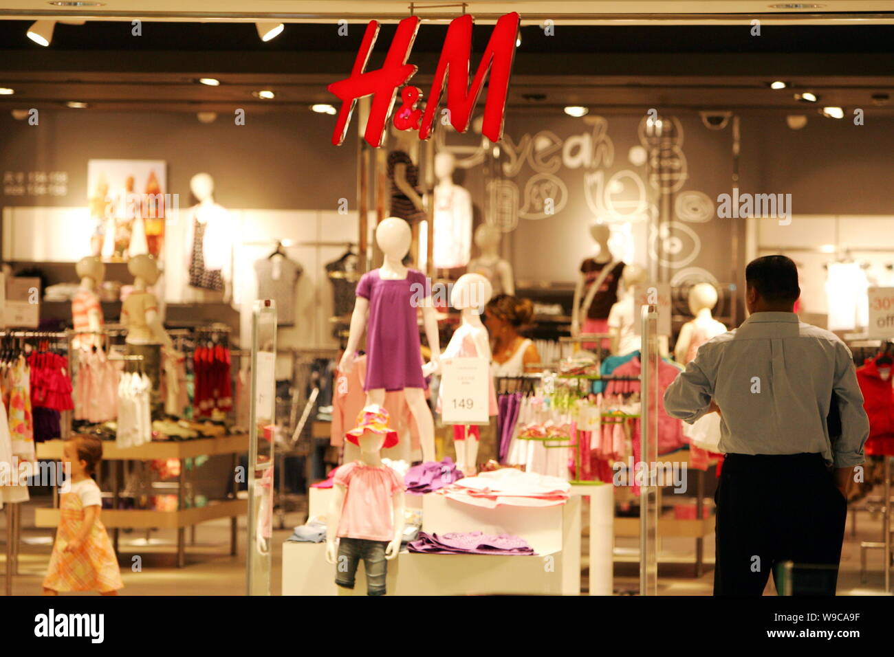 FILE--A man stands at an H&M boutique in a shopping mall in Shanghai,  China, 22 May 2007. Swedish clothing retailer Hennes & Mauritz (H&M) plans  t Stock Photo - Alamy
