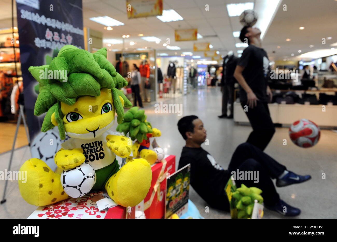 Chinese football players show football skills to promote toys of Zakumi, the official mascot of 2010 FIFA World Cup South Africa, at a department stor Stock Photo
