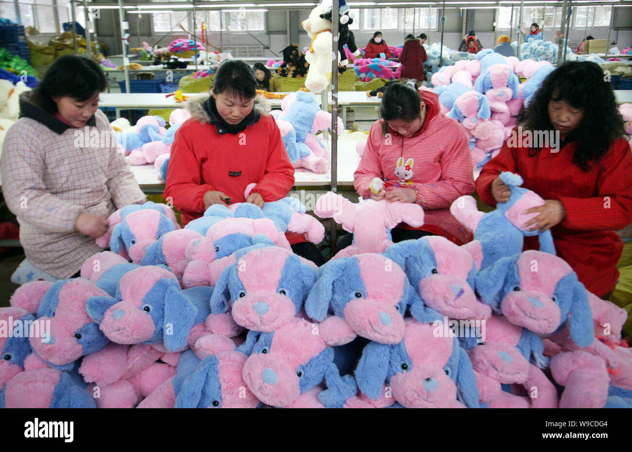 Female Chinese factory workers make toy dogs at the factory of