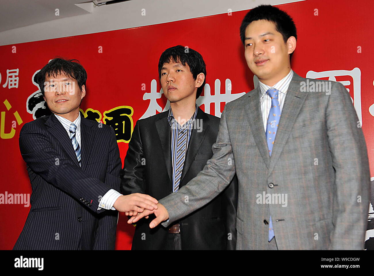 From Left Japans Takao Shinji South Koreas Lee Chang Ho And Chinas Chang Hao Pose At The 11th Round Of The 10th Nong Shim Cup Go Championship In Sh Stock Photo