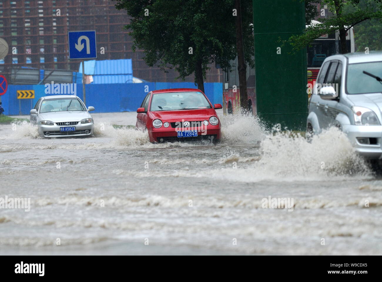 Cars drive through a flooded street after heavy rain caused by Tropical Storm Parma in Haikou city, south Chinas Hainan province, Monday, 12 October 2 Stock Photo