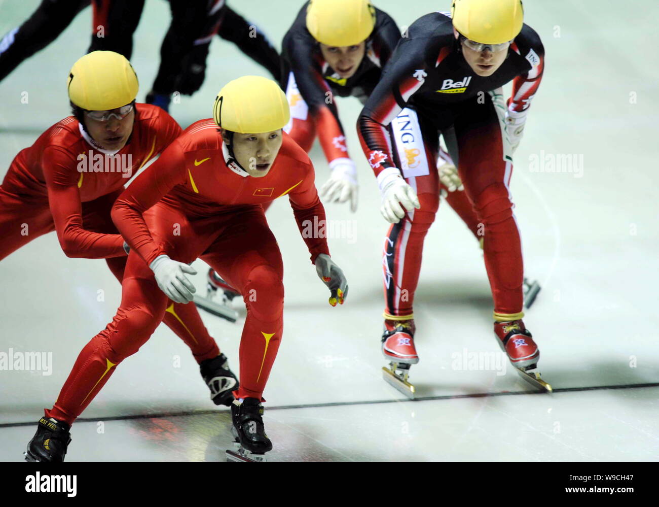 Chinese (left) and Canadian skaters compete at the final of the Mens