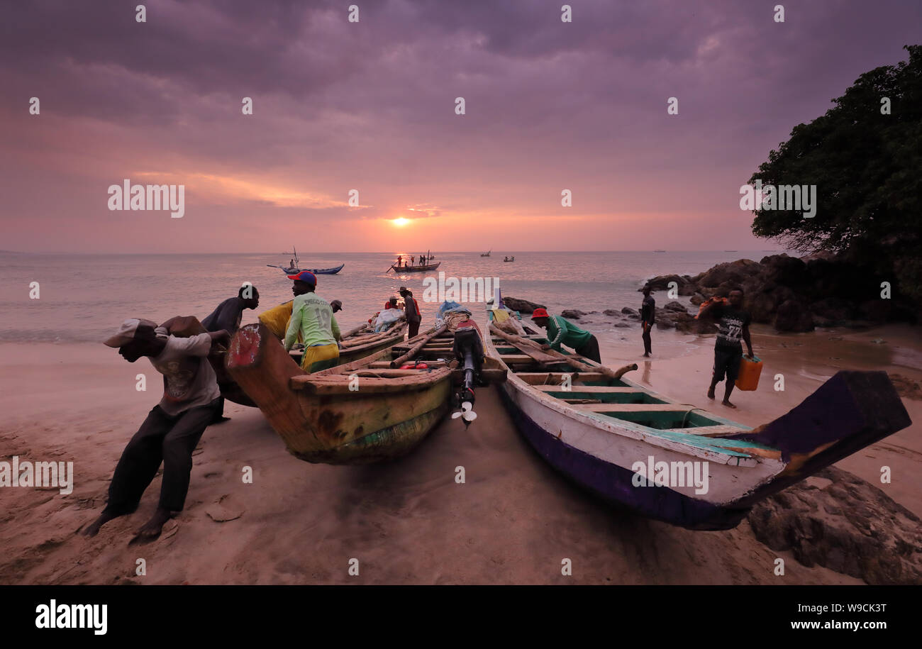 Fisher launch a boat in Senya Beraku, Ghana. Illegal fishing by foreign vessels threatens traditional fishing villages in Ghana Stock Photo