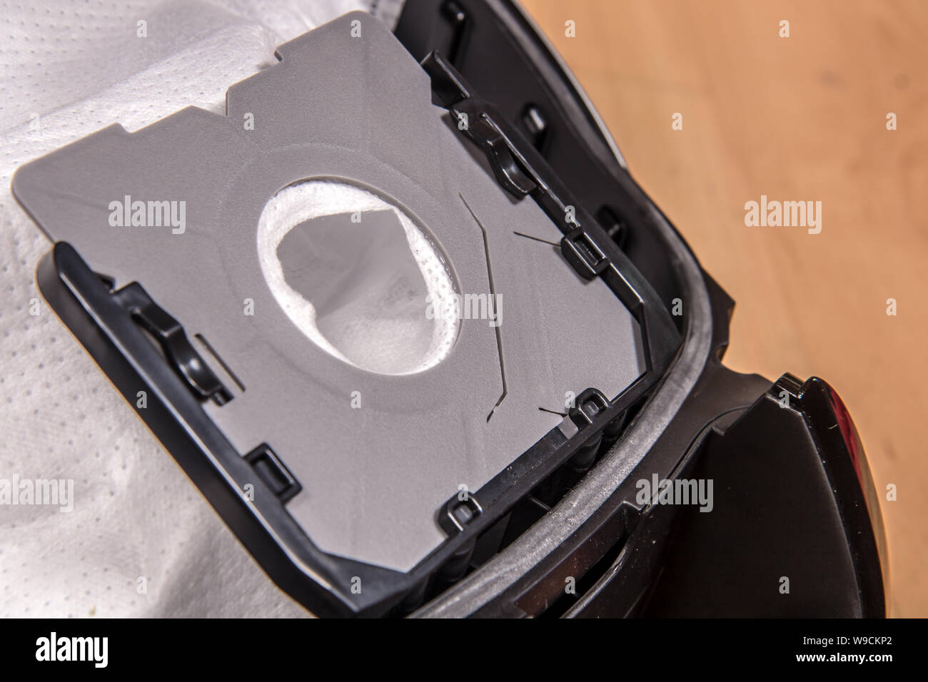 A closeup view of open vacuum cleaner with empty bag for dirt Stock
