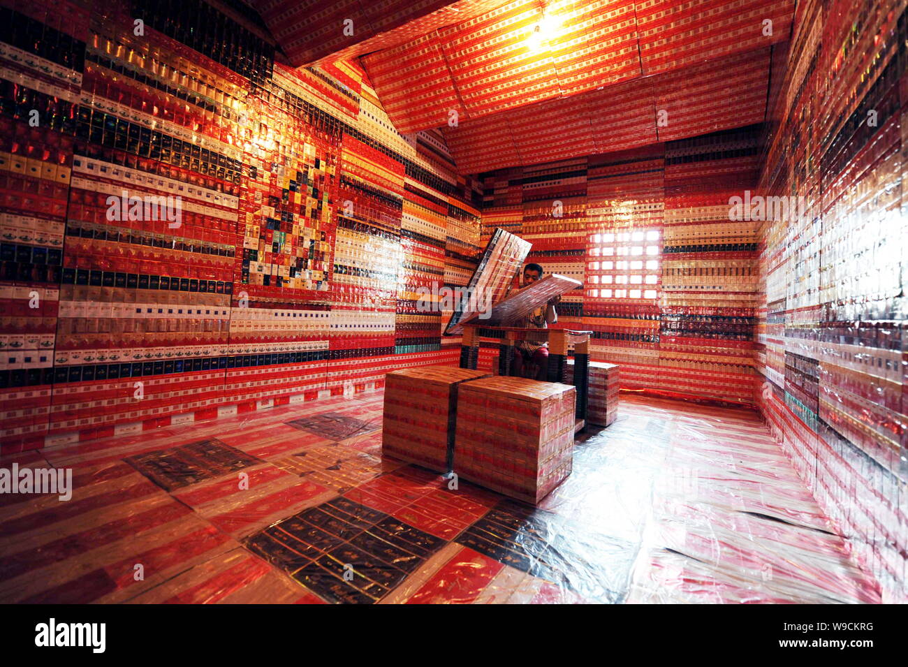 Chinese collector Wang Guohua looks at his collections of cigarette ...