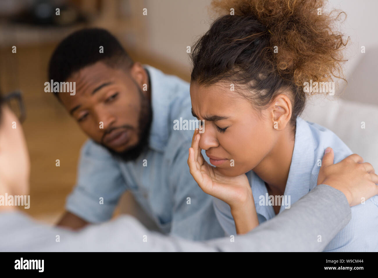 Counselor Comforting Desperate Afro Woman Crying At Couples Therapy Stock Photo