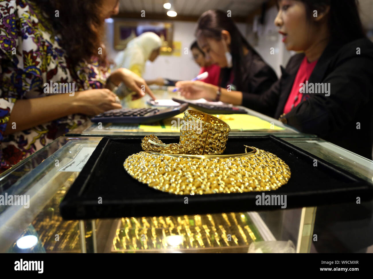 Yangon, Myanmar. 13th Aug, 2019. A customer shops for gold ornaments at
