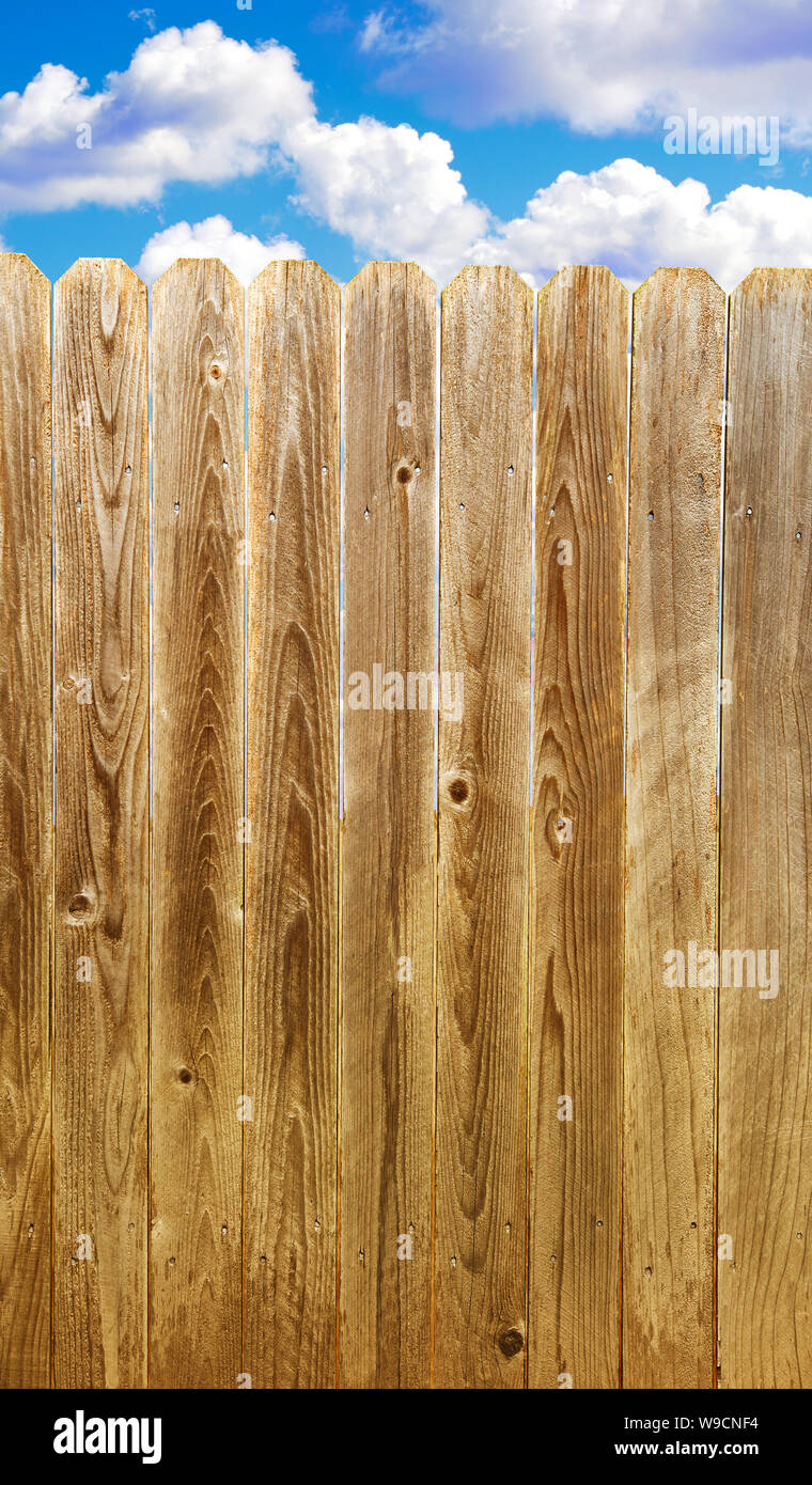 Rustic wooden fence with blue sky and clouds Stock Photo - Alamy