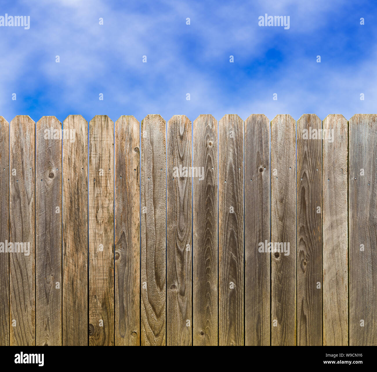 Rustic wooden fence with blue sky and clouds Stock Photo - Alamy