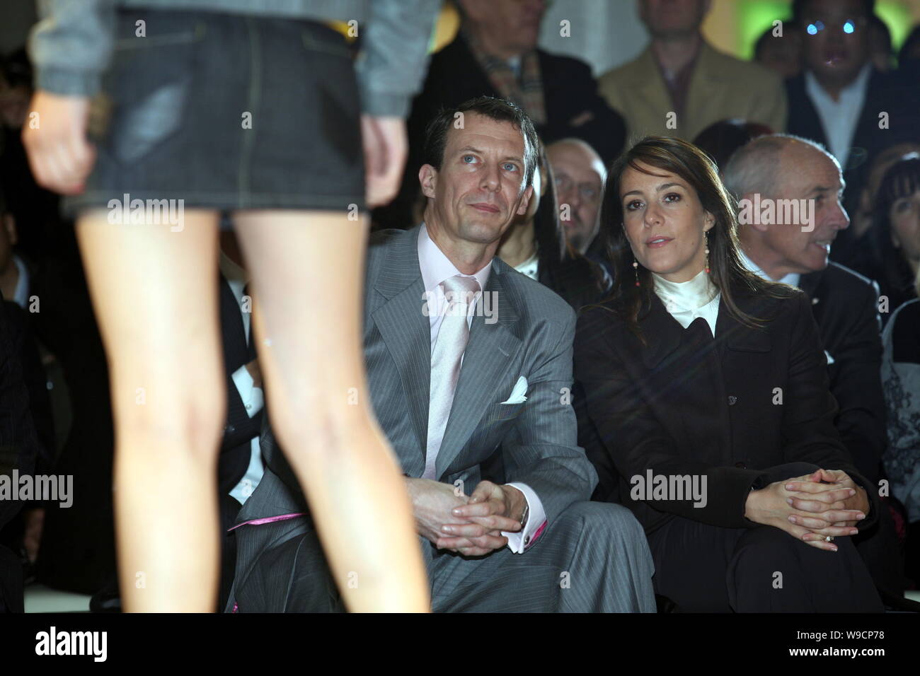 Prince Joachim, front left, and Princess Marie, front right, of Denmark look at a model parading during a promotional event entitled Danish Fairytales Stock Photo