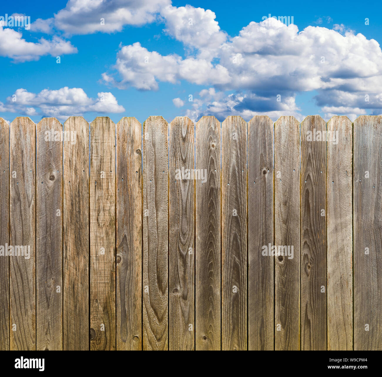 Rustic wooden fence with blue sky and clouds Stock Photo - Alamy
