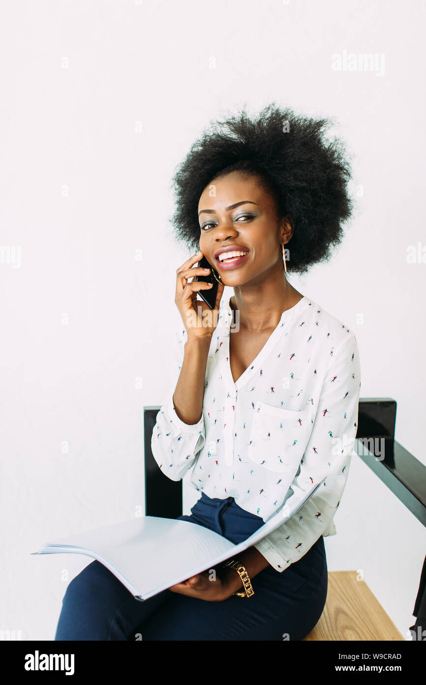 Young smiling african american business woman using the phone, isolated ...