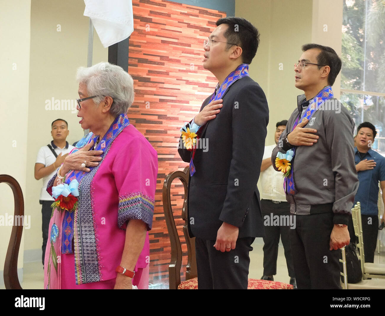 Secretary of Education, Leonor Briones, Cabinet Member Karlo Nograles and Mayor Isko Moreno sing the Philippine National Anthem during the 132nd Anniversary.Manila Mayor, Francisco 'Isko Moreno' Domagoso, graced the 132nd Anniversary and the unveiling of the newly retrofitted building of the Philippines' National Library. Stock Photo