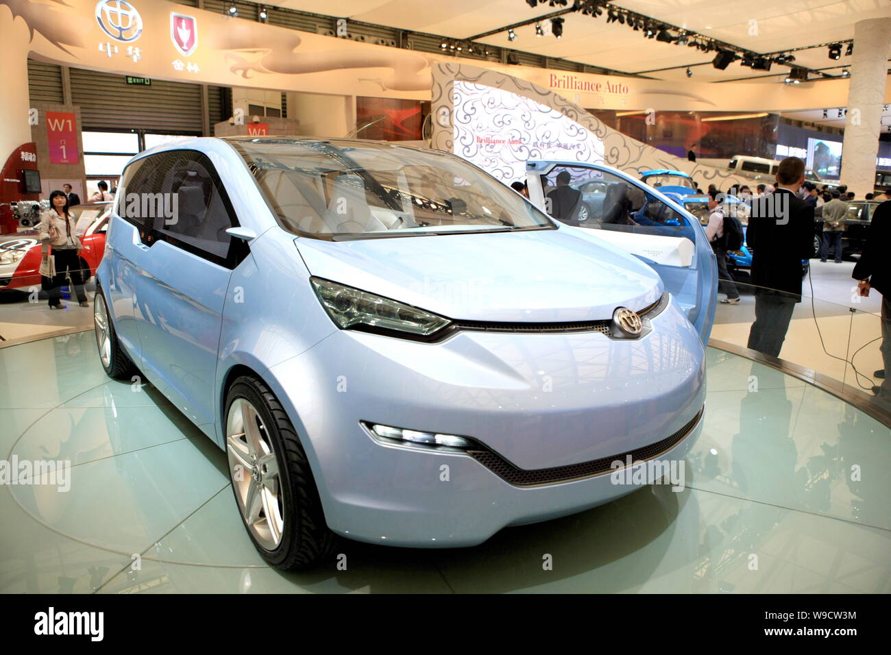 Visitors look at a Brilliance Auto EV (Electric Vehicle) Concept at the