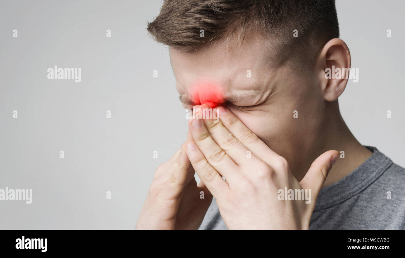 Stressed young man suffering from sore nose Stock Photo - Alamy