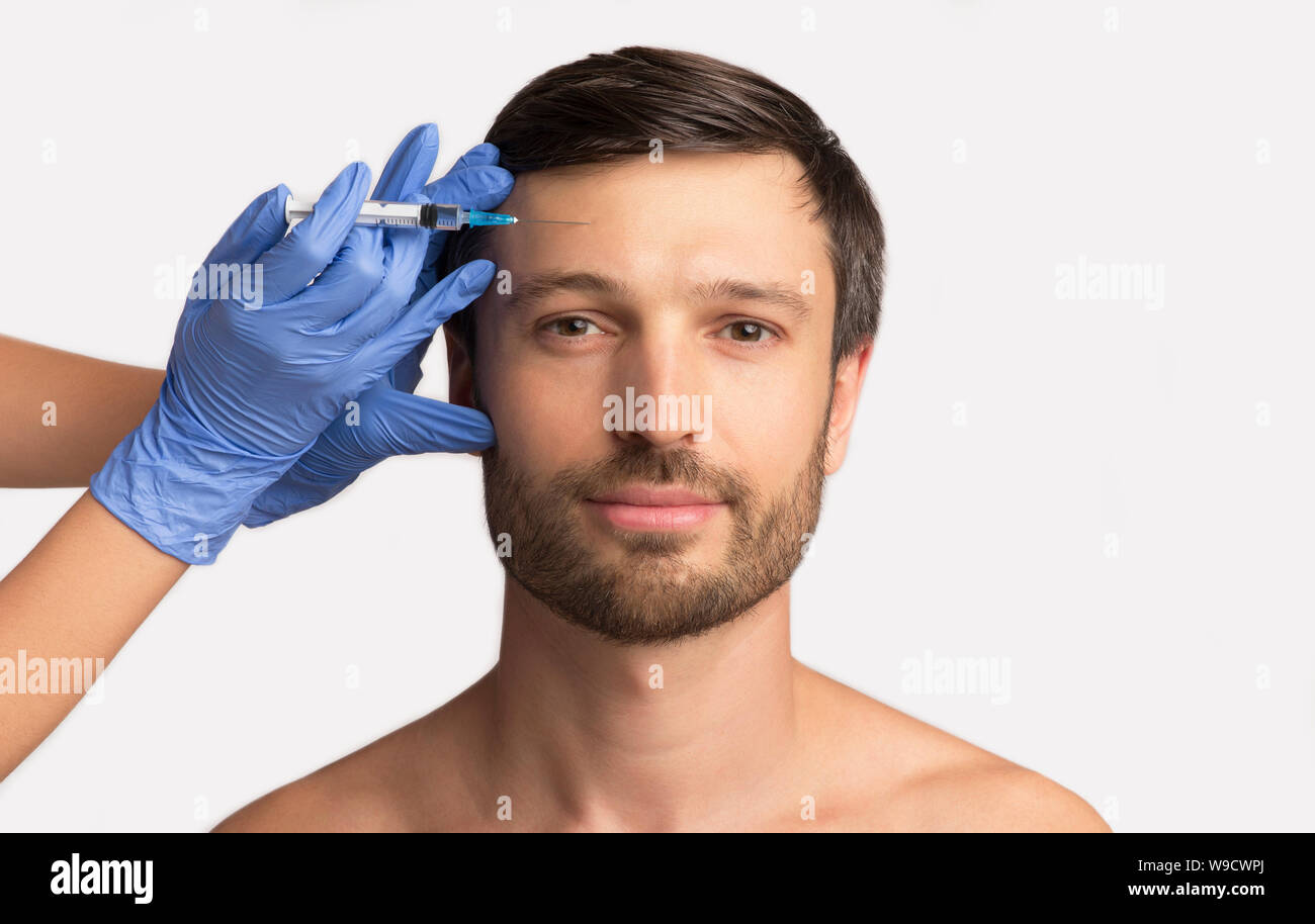Handsome Man Receiving Hyaluronic Acid Injection, Isolated On White Stock Photo