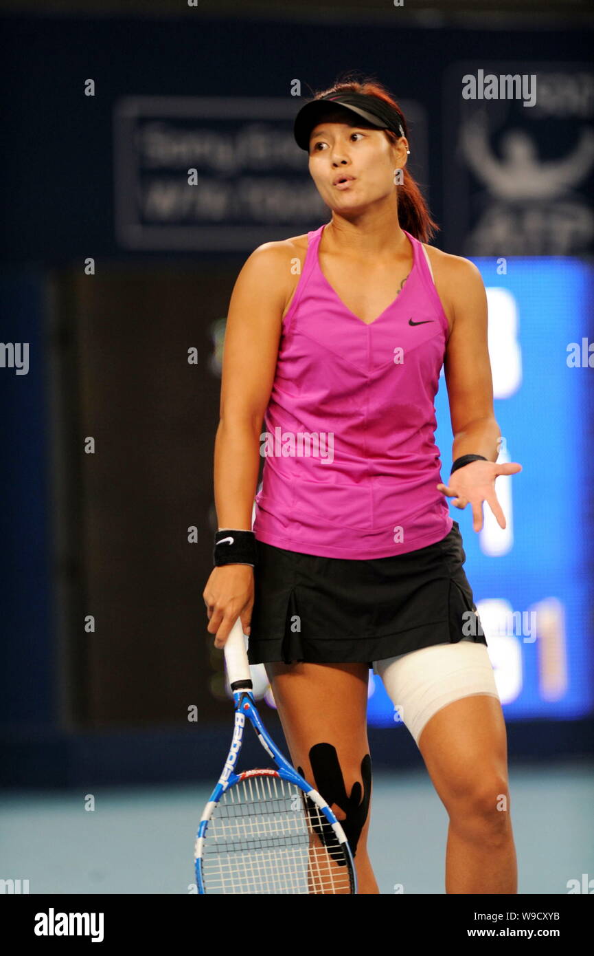 Chinas Li Na reacts while competing against Elena Dementieva of Russia during the second round of the womens singles of the China Open 2009 in Beijing Stock Photo