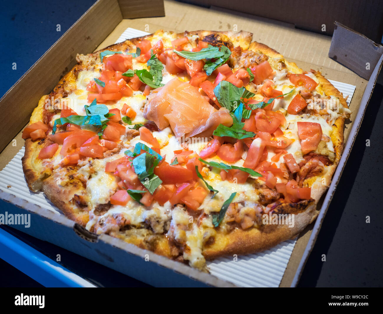 A mist pizza (smoked salmon, crab, scallions, and tomato pizza) from Steveston Pizza Company in Steveston Village, Richmond, British Columbia, Canada. Stock Photo