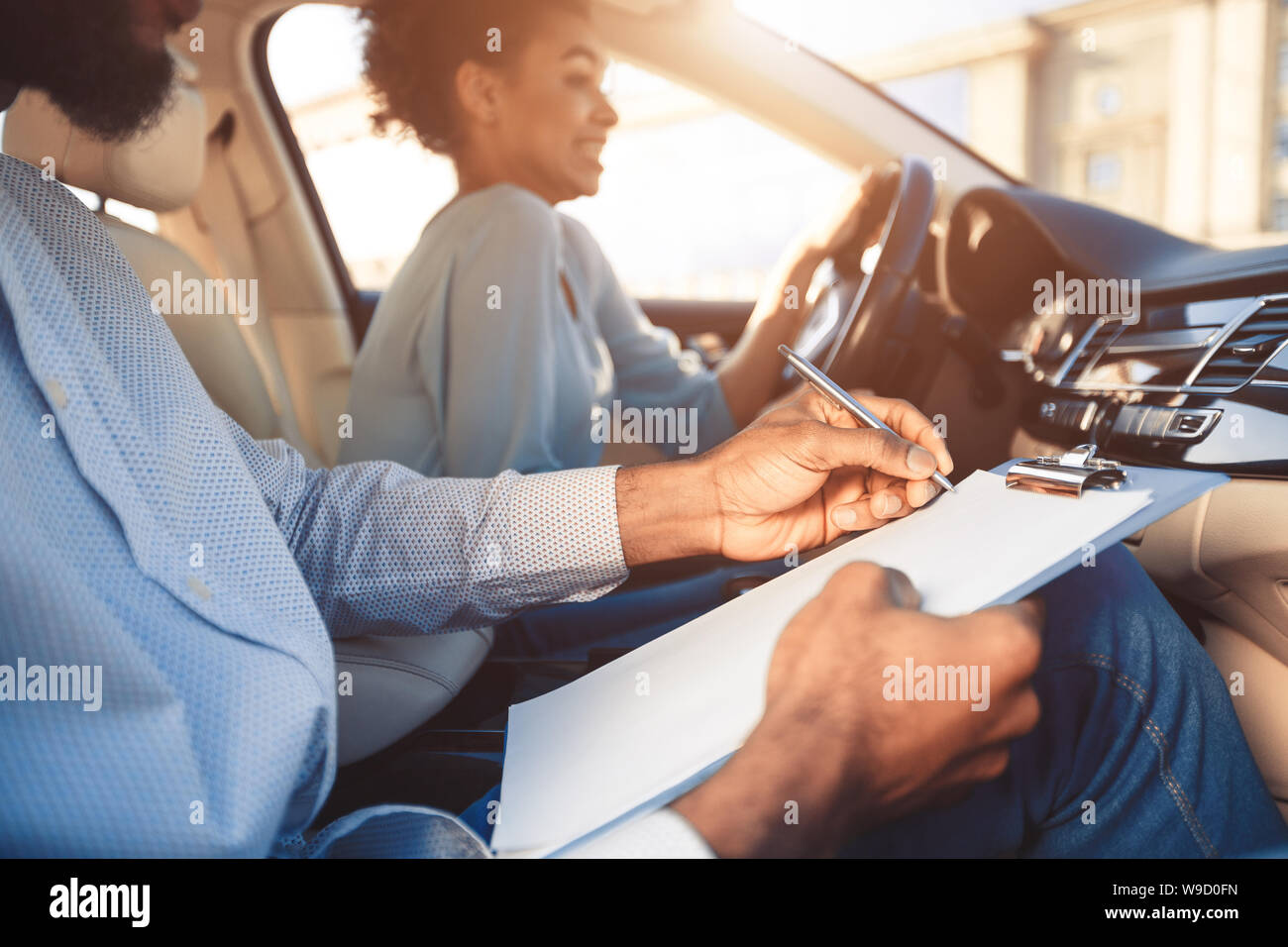 Driving test. Young woman driving car feeling inexperienced Stock Photo