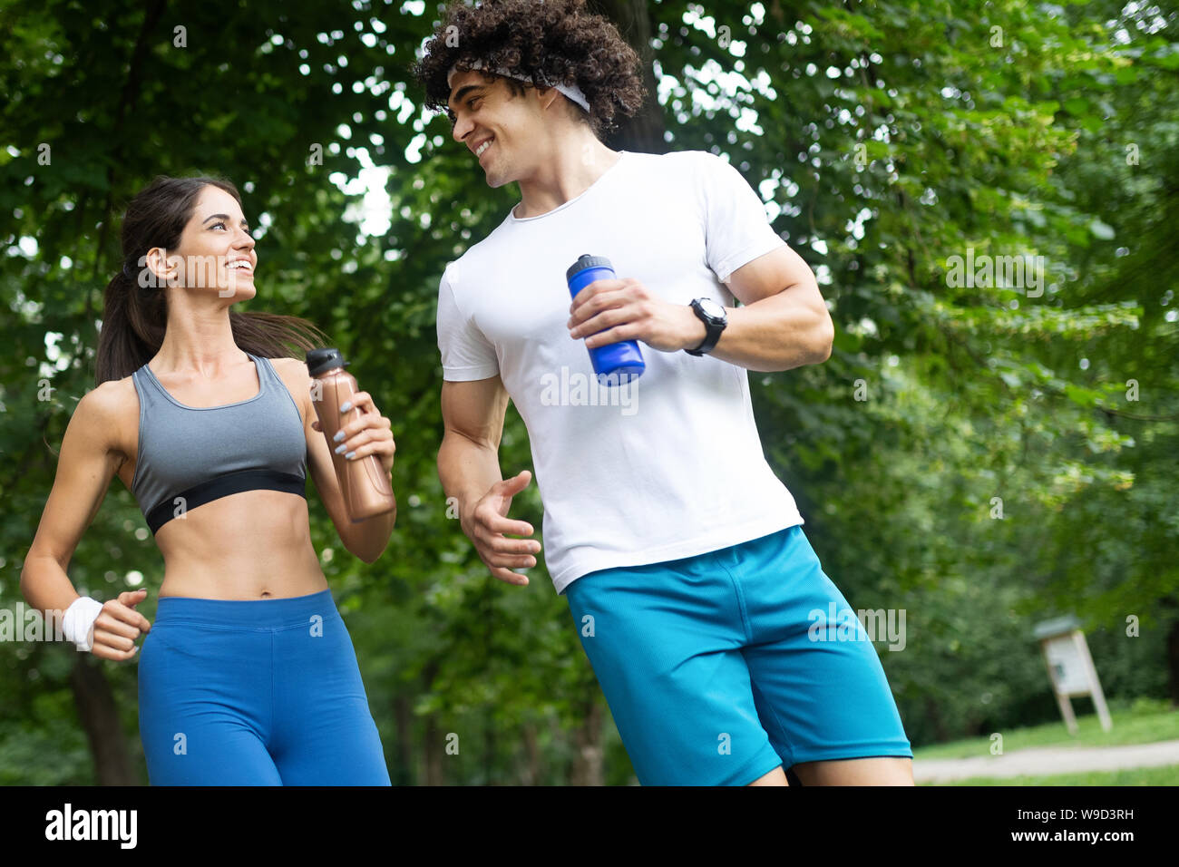 Happy couple running and jogging together outdoor Stock Photo - Alamy