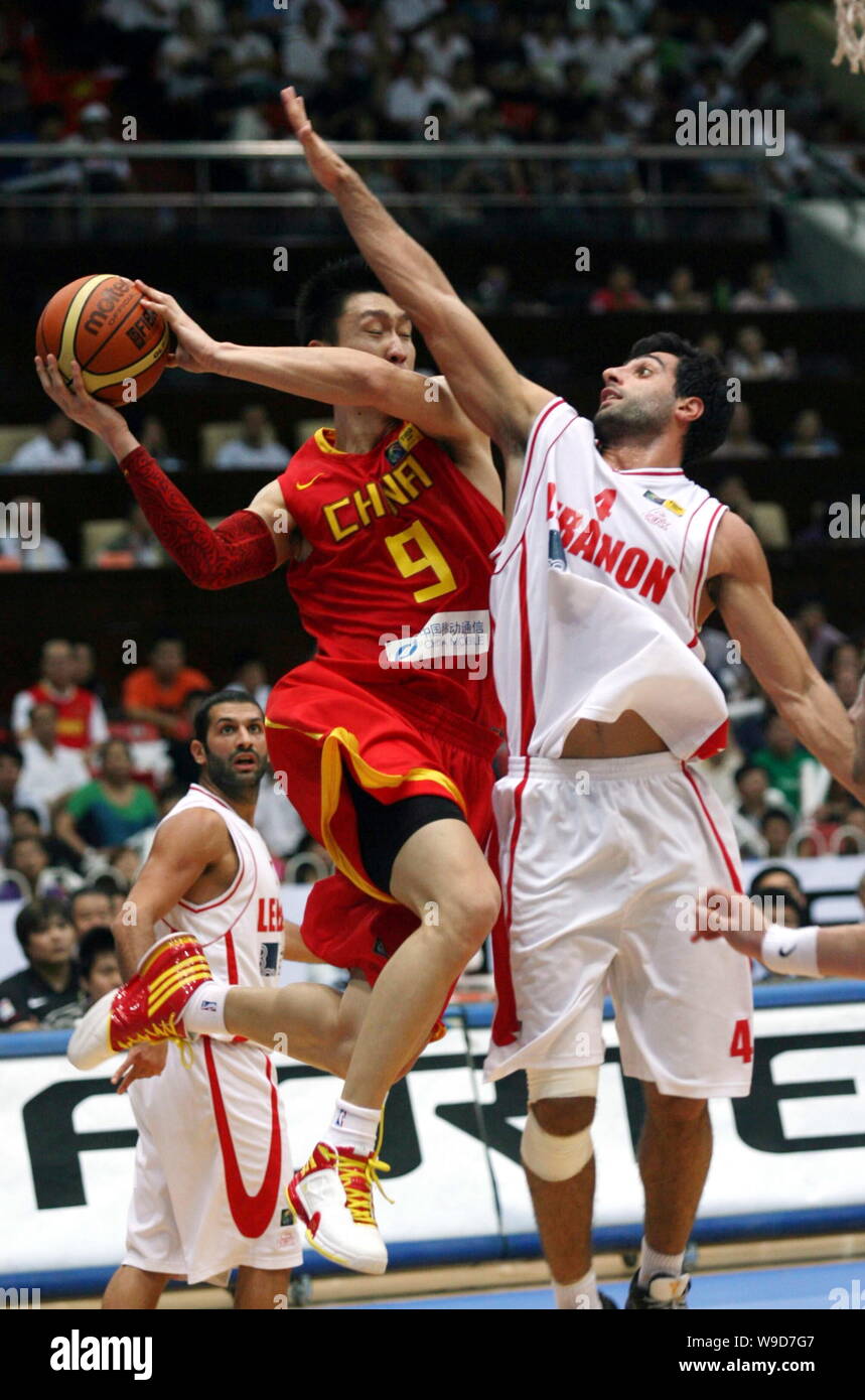 Chinas Sun Yue, front left, competes with Jean Abdel-Nour of Lebanon, right, during a match of the 25th FIBA Asia Championship for Men in Tianjin, Chi Stock Photo