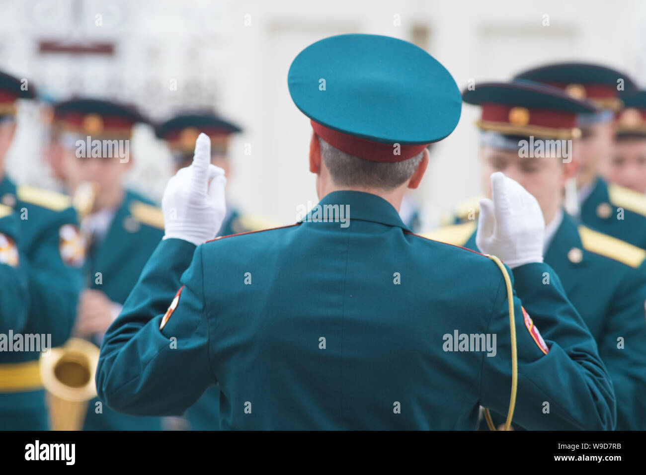 A wind instrument parade - people in green costumes listening to the ...