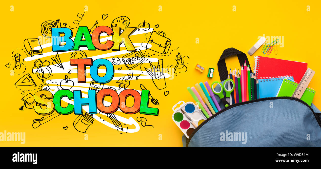 Backpack with stationery inside on yellow background Stock Photo