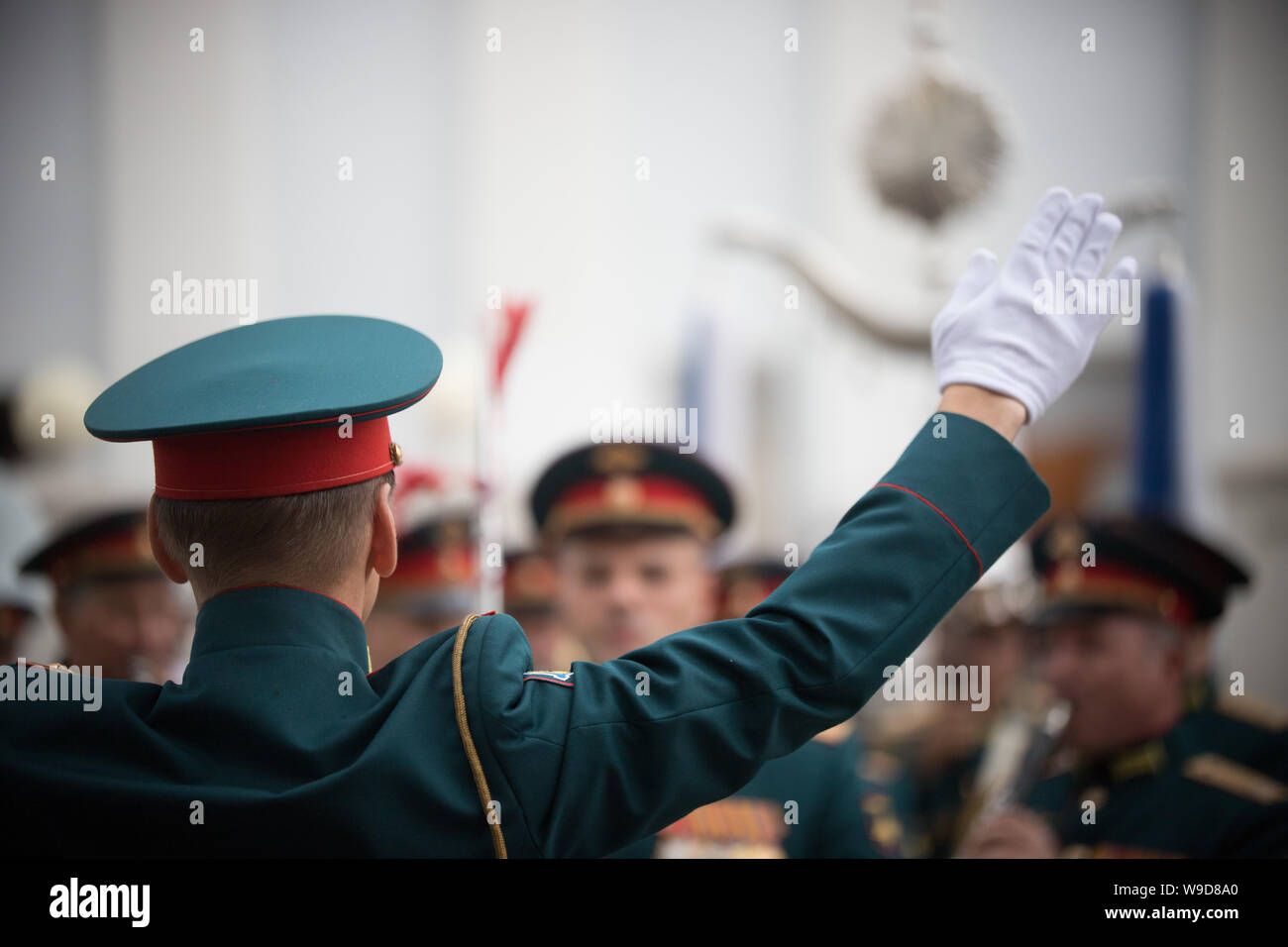 A wind instrument parade - people in green costumes follows the ...