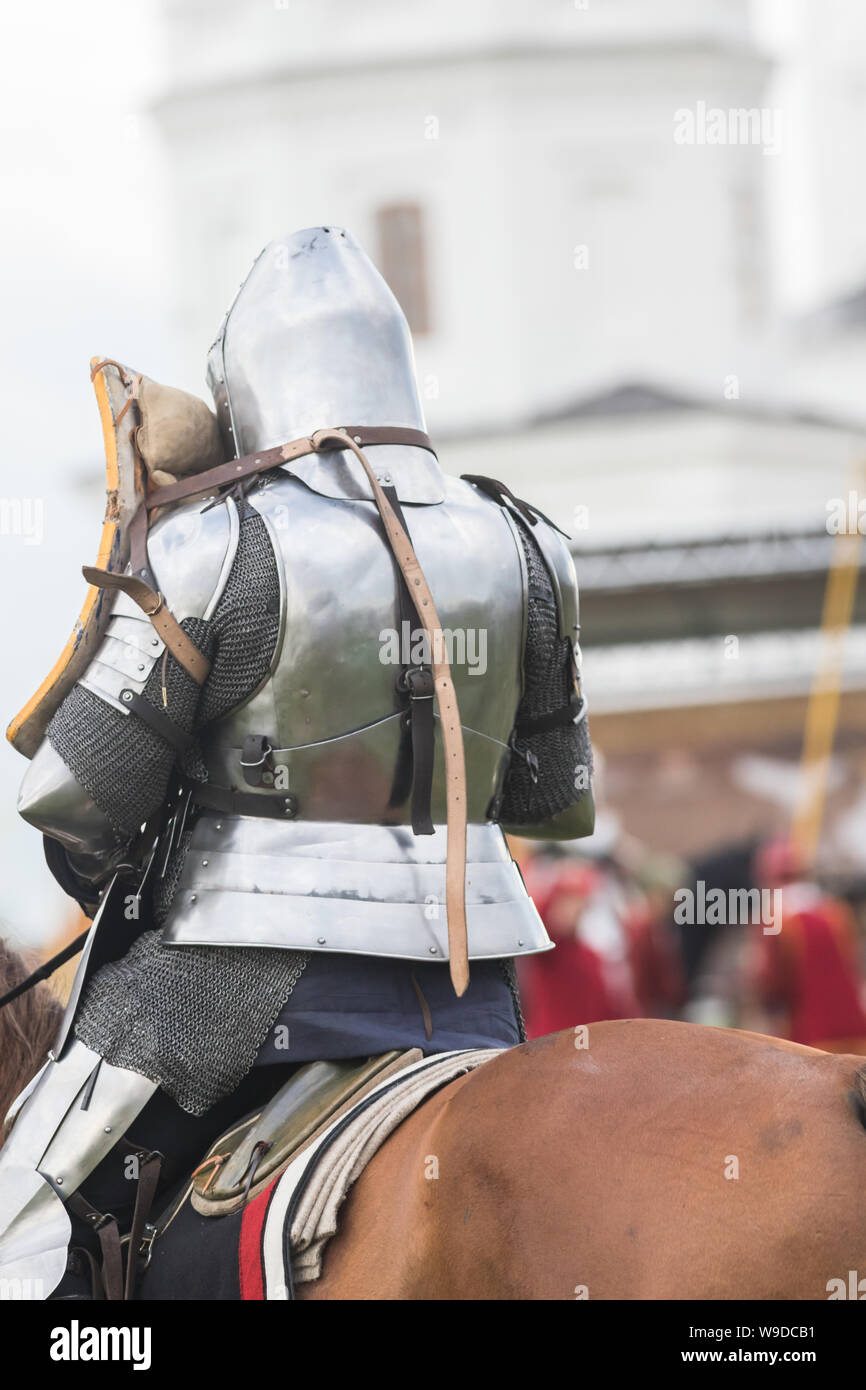 A man knight in helmet riding a brown horse Stock Photo