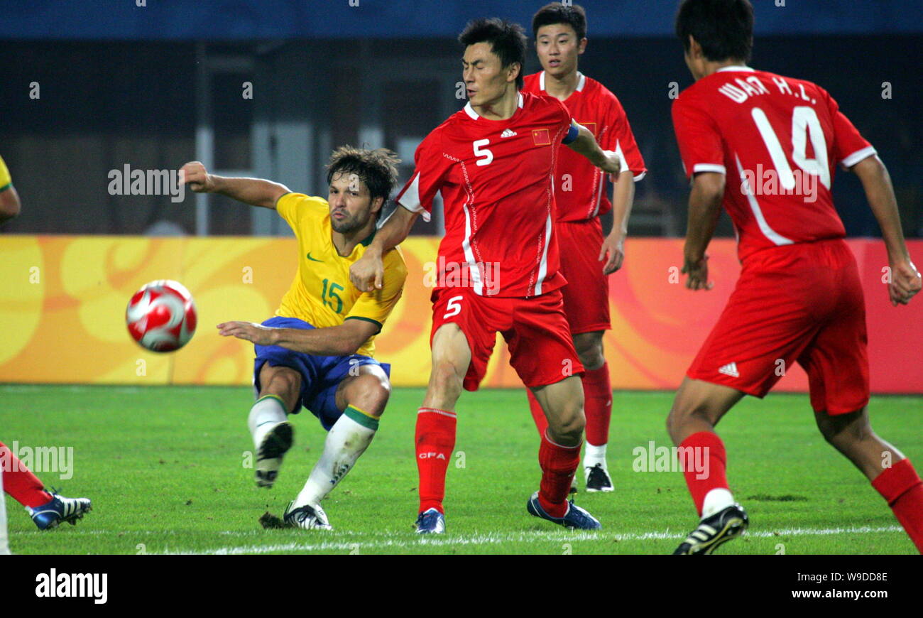 Brazils Diego Ribas da Cunha, left, shoots amid Chinas players at a Group C match of the Mens Soccer Preliminary of the Beijing 2008 Olympic Games at Stock Photo