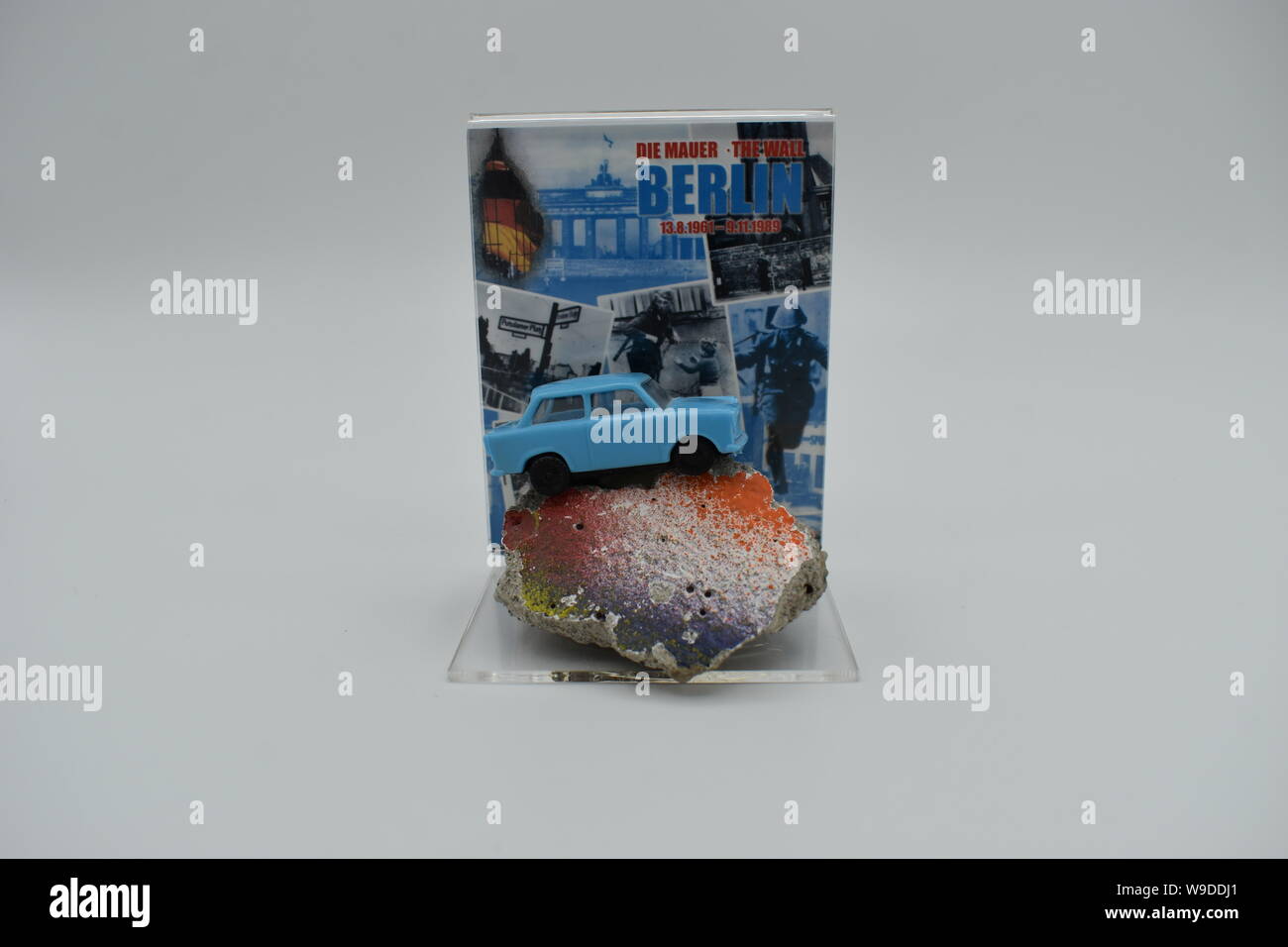 Souvenir of the Berlin Wall.  A piece of the wall and a tiny model of a Trabant car.  Has a certificate of authenticity on the reverse. Stock Photo