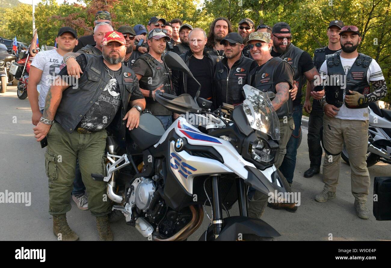 Russian President Vladimir Putin, center, poses with members of the Night Wolves biker club at the Babylon Shadow bike show and camp August 10, 2019 near Sevastopol, Crimea, Russia. Stock Photo