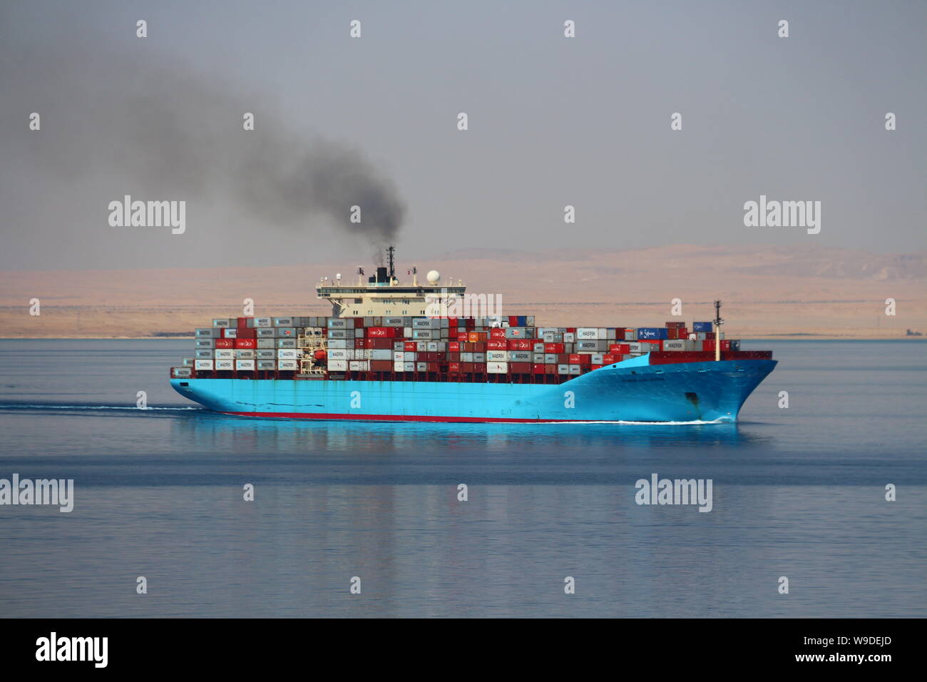 Container ship Maersk Karlskrona departing the Suez Canal and proceeding into the Red Sea. Stock Photo