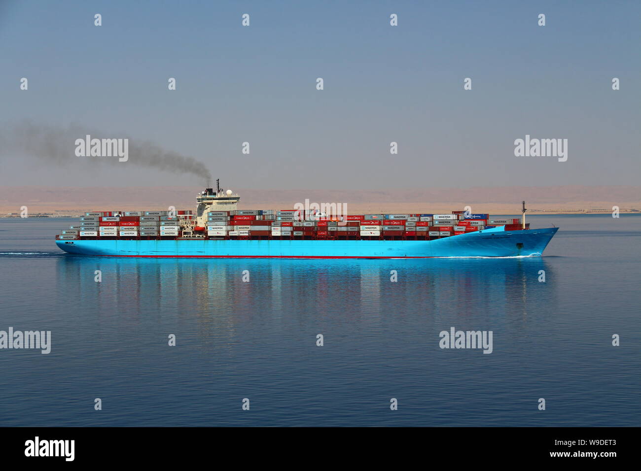 Container ship Maersk Karlskrona departing the Suez Canal and proceeding into the Red Sea. Stock Photo