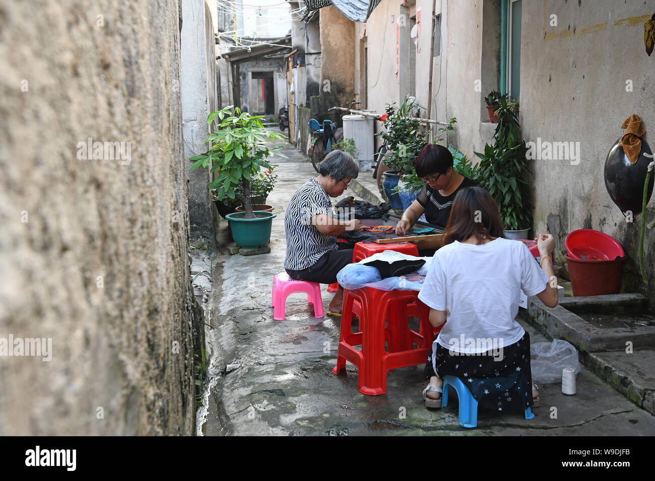 Beijing, China's Guangdong Province. 17th July, 2019. Wei Jingming (C) sews a piece of needlework with her daughter-in-law and cousin in Tahou Village of Linxi Township, Chaozhou, south China's Guangdong Province, July 17, 2019. Credit: Liang Xu/Xinhua/Alamy Live News Stock Photo