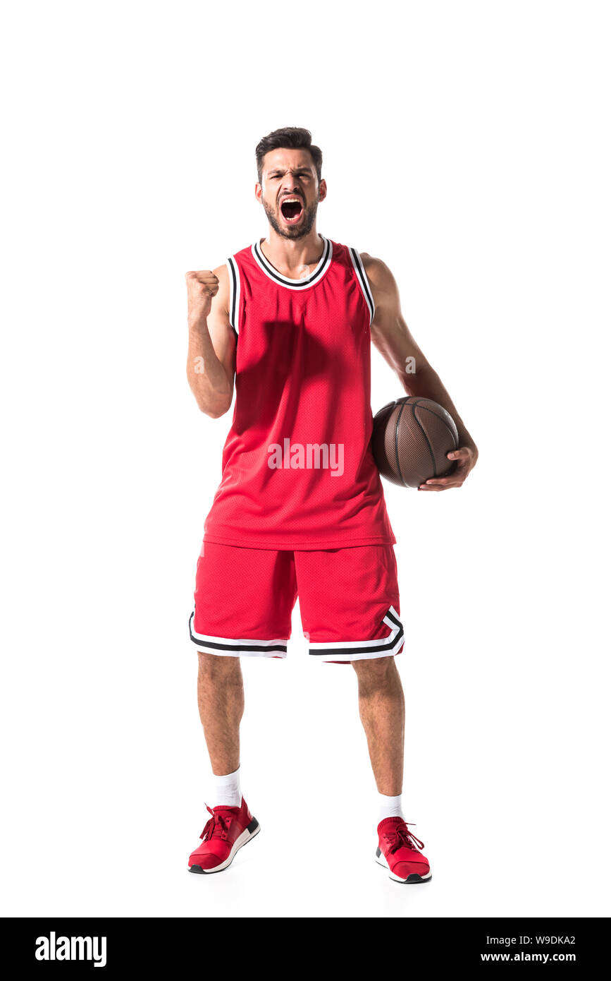 basketball player in uniform with ball cheering with clenched hand