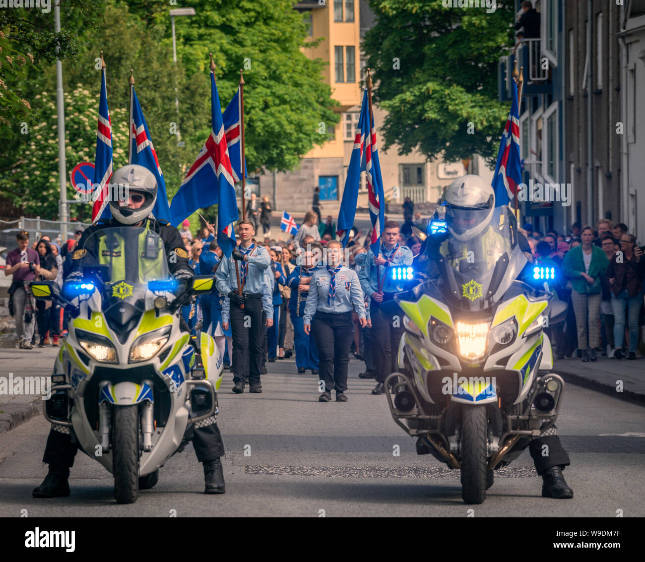 Scouts being escorted by Icelandic police during a parade, celebrating Independence day, Reykjavik, Iceland Stock Photo