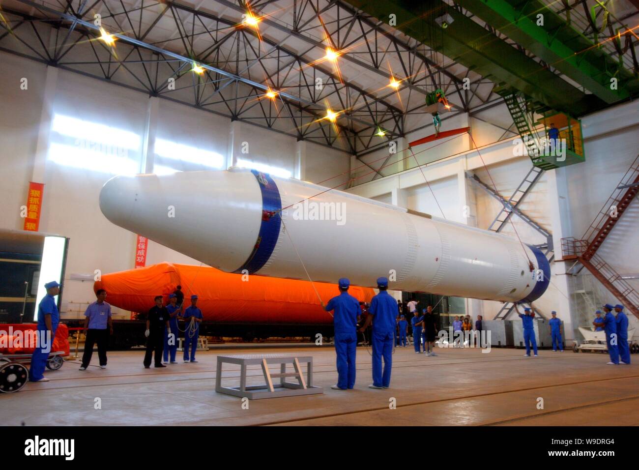 Chinese aeronautical scientists unload a rocket booster of a Long March 2F (CZ-2F) rocket during the preparation for the Shenzhou VII manned spaceflig Stock Photo
