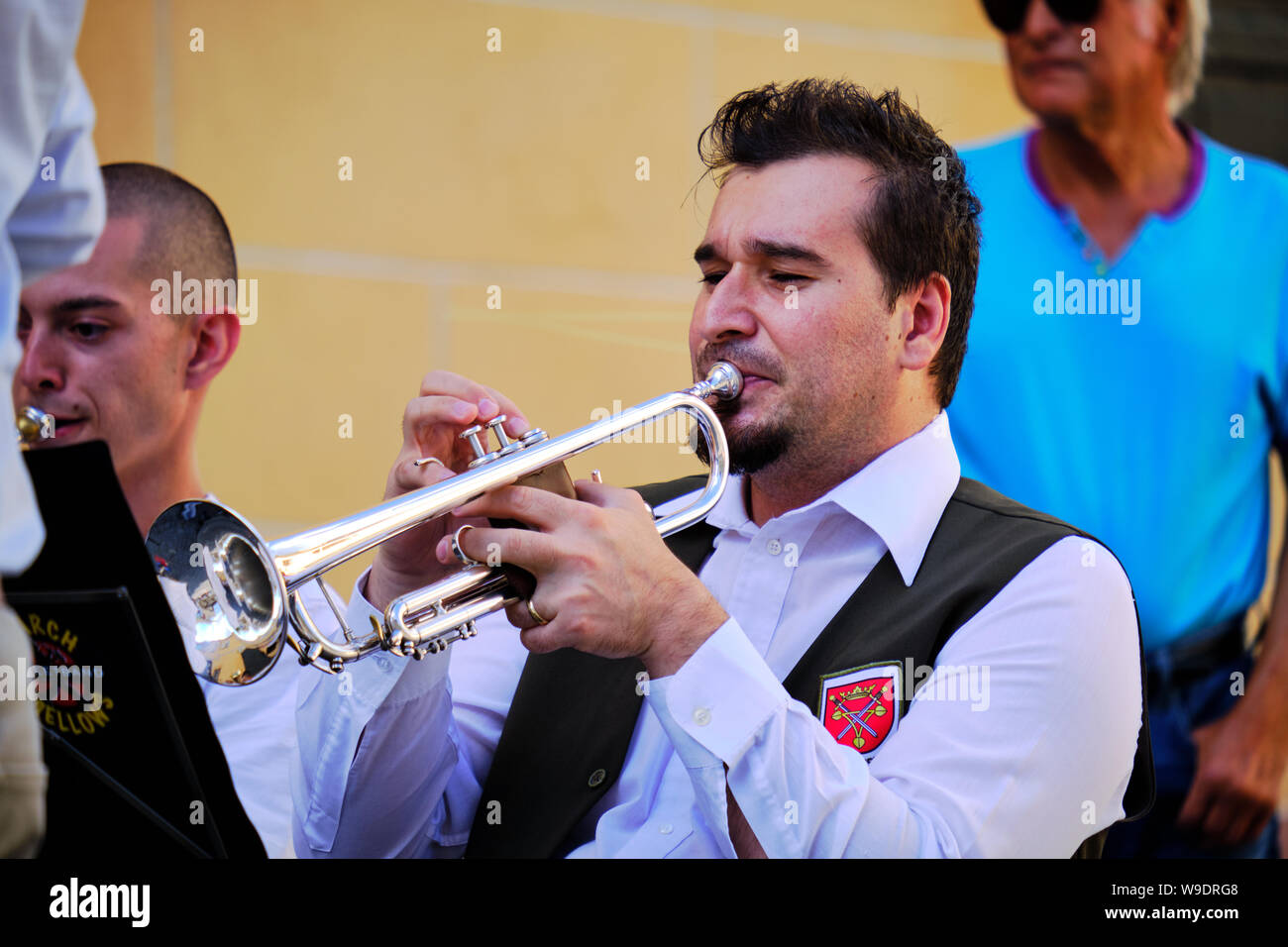 Portrait of Man playing the trumpet during an outdoor performance in a city square. Image of Head, hands and instrument. Sibiu, Romania: July 9, 2019 Stock Photo