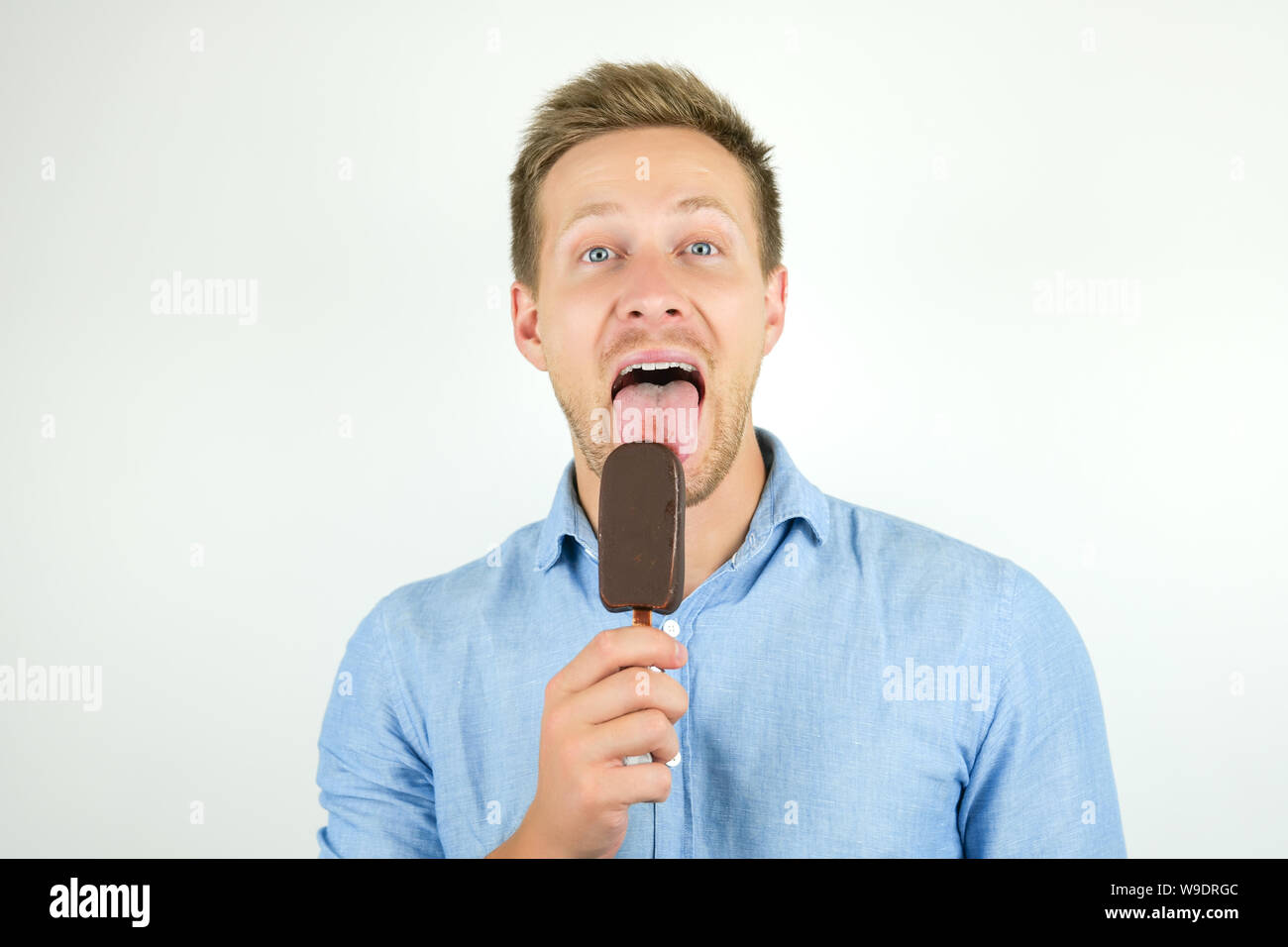 handsome young man licks tasty chololate icecream on isolated white background Stock Photo Alamy
