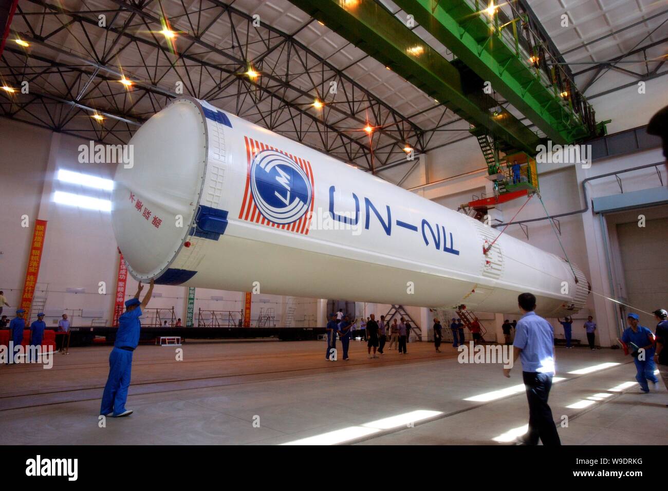 Chinese aeronautical scientists unload the first stage of a Long March 2F (CZ-2F) rocket during the preparation for the Shenzhou VII manned spacefligh Stock Photo