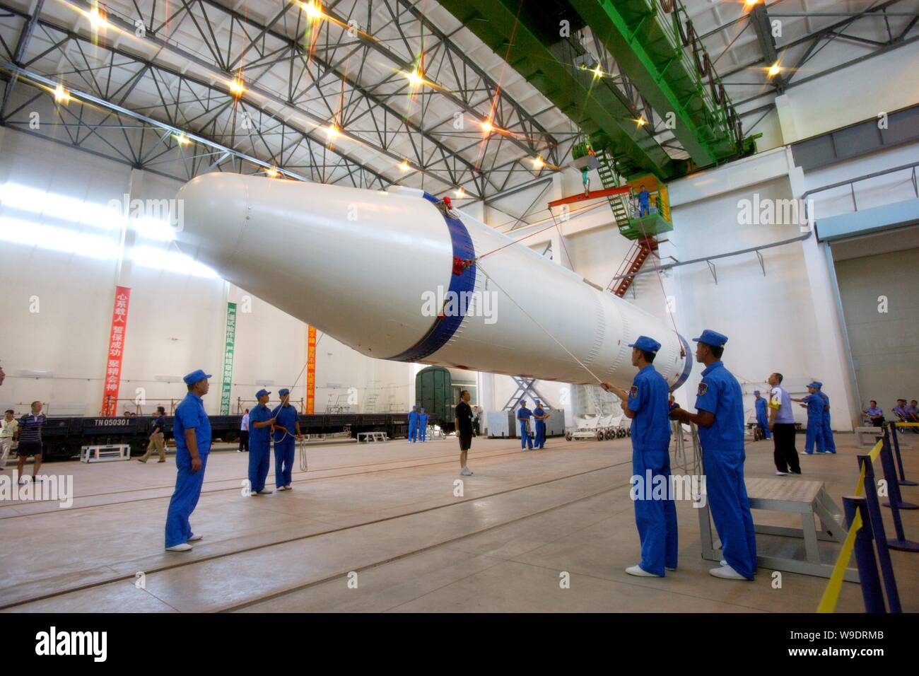 Chinese aeronautical scientists unload a rocket booster of a Long March 2F (CZ-2F) rocket during the preparation for the Shenzhou VII manned spaceflig Stock Photo