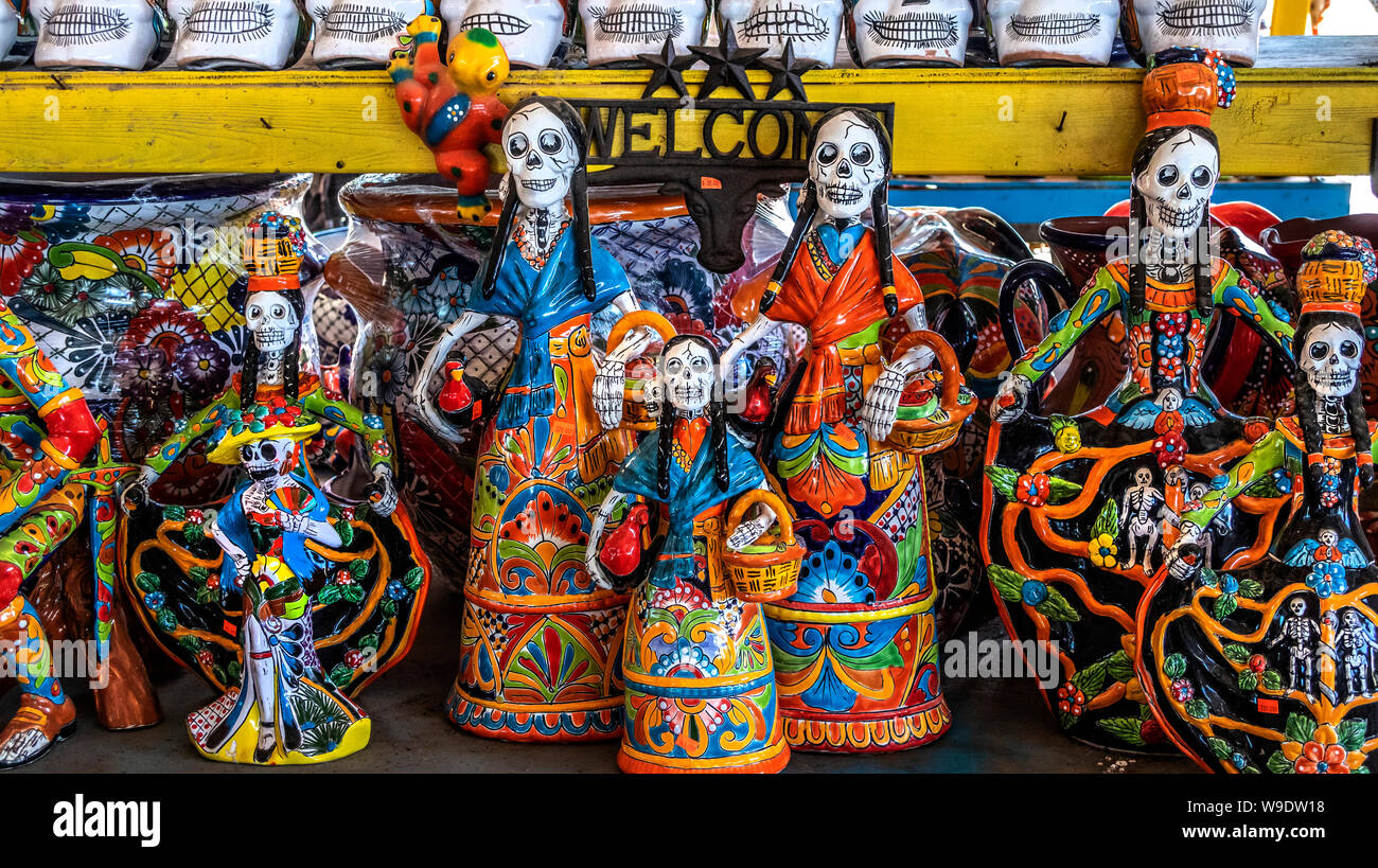 Pottery day of the dead skeletons on sale at a roadside shop, Texas
